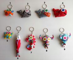 six different keychains are arranged in the shape of animals