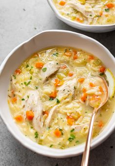 two white bowls filled with chicken and vegetable soup