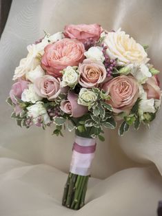 a bridal bouquet with pink and white flowers