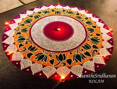 an orange and white decorated umbrella with a red candle in the center, surrounded by lights