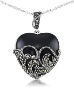 An impressive block of onyx is carved to a smooth domed heart shape. Meticulous lace work in sterling silver and genuine marcasite wrap around this dramatic pendant. Macy's Black Jewelry For Gift, Macy's Black Jewelry For Gifts, Macy's Black Jewelry Gift, Black Heart-shaped Formal Necklace, Black Heart-shaped Necklace For Formal Occasions, Black Vintage Jewelry For Valentine's Day, Vintage Black Jewelry For Valentine's Day, Formal Black Heart-shaped Necklace, Silver Heart-shaped Jewelry With Black Enamel