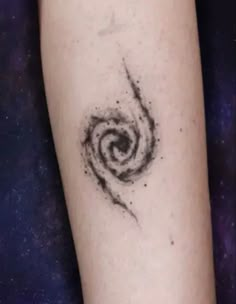 a black and white spiral tattoo on the left arm with space in the back ground