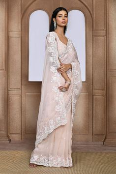 Peach organza saree with placement butti, floral pattern, tonal thread, sequin, cut dana and pearl embroidery.
Components: 1
Pattern: Embroidered
Type Of Work: Sequin, Thread, Pearl and Cut Dana Work
Fabric: Organza
Color: Peach
Other Details: 
Scalloped cut work hem details
Note: The stitched blouse worn by the model is not for sale
Occasion: Sangeet,Destination Wedding - Aza Fashions Pearl Saree, Saree Women, Pearl Embroidery, Saree For Women, Embroidered Saree, Organza Saree, Fashion App, Cut Work, Not For Sale