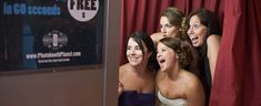 four beautiful women standing next to each other in front of a red curtain with their mouths open