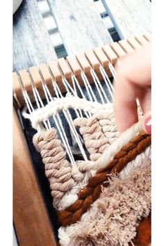 someone is weaving something on an old loom