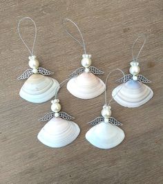 six seashell ornaments with angel wings and pearls