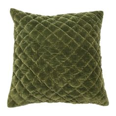 a green velvet pillow on a white background