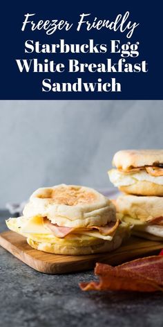 three breakfast sandwiches on a cutting board with bacon and eggs in the background text reads freeze friendly starbuck's egg white breakfast sandwich