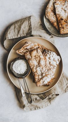 two slices of pie on a plate with powdered sugar