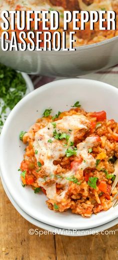 a white bowl filled with pasta and topped with parsley next to a casserole dish