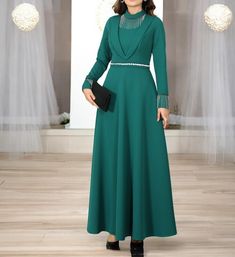 Made of double crepe fabric. It is an unlined dress. There is a zipper on the back. The dress is 155 cm long. There is a chain detail on the collar and sleeves Elegant Green Evening Abaya, Elegant Evening Green Abaya, Green Long-sleeved Party Abaya, Green Long Sleeve Abaya For Party, Elegant Green Maxi Length Abaya, Maxi Length Dress For Eid Banquet, Maxi Dress For Eid Banquet, Eid Banquet Maxi Dress, Green Long Sleeve Abaya For Evening