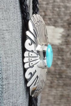 This turquoise and sterling silver bolo tie was made by Navajo silversmith Rosita Singer. The back is signed T&R Singer and stamped sterling.Tie Length: 23"Length: 2 1/4"Width: 1 7/8"Tips:Length: 2 1/8"Width: 1/4"Free shipping on all orders! We ship with USPS and always include tracking. All orders ship within a day of payment.Returns are accepted up to 30 days after you receive your order. Just send us a message. Our shop offers cash back or store credit. The item must be returned in new condit Blue Turquoise Concho Necklace As A Gift, Western Sterling Silver Turquoise Necklace, Western Style Sterling Silver Turquoise Necklace, Southwestern Blue Bolo Ties As A Gift, Southwestern Blue Bolo Tie For Gift, Artisan Turquoise Concho Necklace Gift, Adjustable Southwestern Silver Turquoise Necklace, Southwestern Sterling Silver Turquoise Concho Necklace, Artisan Turquoise Bolo Ties With Concho