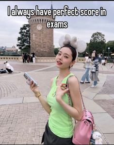 a woman holding a cell phone in front of a clock tower with text that reads, i always have perfect score in exam