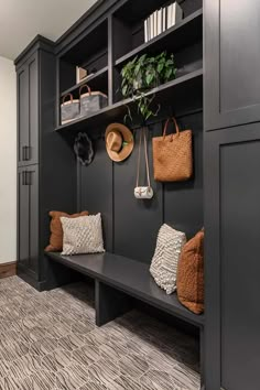 the entryway is decorated in black and gray with lots of storage space for purses