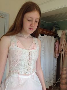 "wonderful antique camisole, with a button and loop front closure. strong valenciennes lace. with a multicolor coral pink silk ribbon bust 78 cm 30,5\" waist 68 cm 26,5\" length 43 cm 17\" in excellent condition" Pink Lace Trim Underbust Corset, Pink Underbust Corset With Lace Trim, Pink Lace Wedding Corset, Feminine Lace Corset With Lace Bodice, Feminine Lace Corset With Lace Trim, Pink Lace Corset With Boned Bodice, Feminine Lace Bodice Corset, Pink Lace Underbust Corset, Fitted Pink Lace Top With Lace Trim