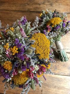 a bouquet of flowers sitting on top of a wooden table