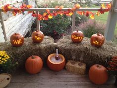 pumpkins with names carved into them sitting on hay