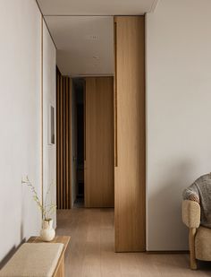 a living room with a couch, chair and wooden paneled wall in it's center