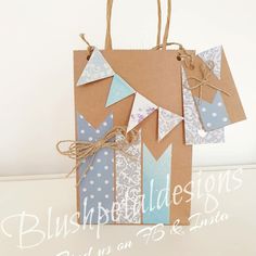 a brown bag with blue and white designs on it, tied up to a string