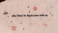 an embroidered piece that says she lives in daydreams with me