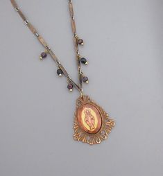 "Vintage Jewelry - Vintage Cameo Necklace - Mother Mary Necklace - Catholic jewelry - One of a Kind Necklace - Religious Jewelry This is such an exquisite vintage one of a kind necklace! This is a beautiful glass cameo image of Mother Mary This delicate piece is from the 1960's with it has a specialty chain and I dangled deep red faceted garnet beads from it.  I'll be adding vintage ladder chain to give it more length.  This is a real special piece.  The pendant is 1 3/4\" long and 1 1/2\" wide Antique Miraculous Medal Necklace As Gift, Antique Miraculous Medal Pendant Jewelry, Victorian Jewelry With Miraculous Medal For Gifts, Antique Dangle Necklaces For Jewelry Making, Vintage Miraculous Medal Jewelry, Filigree Costume Jewelry Necklace For Gift, Miraculous Medal Pendant Jewelry For Wedding, Wedding Miraculous Medal Pendant Jewelry, Miraculous Medal Wedding Pendant Jewelry