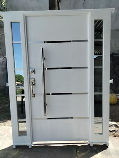 a white door that is open on the side of a building with glass doors and metal handles