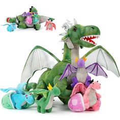 several stuffed animals are sitting together on a white surface, including a dragon and other toys