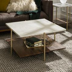 a living room with a couch, coffee table and side tables on carpeted flooring