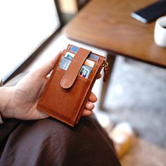 a person is holding a wallet with credit cards sticking out of the front and side