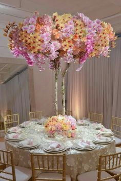 the centerpiece is made out of flowers and branches, along with plates and napkins