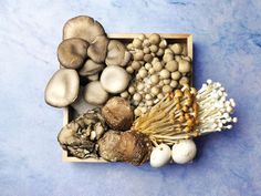 a box filled with different types of mushrooms