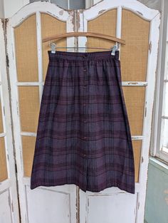 This beautiful skirt is a wool blend, medium weight, warm and soft. Dark lavender with threads of teal, perfect for layers as autumn turns into winter. In very good condition. 12 inches across the waist, 18 inches across the hips and 29 inches long. Fall Purple Midi Skirt, Maroon Plaid Skirt, Victorian Plaid Skirt, Vintage Plaid Pleated Skirt, Vintage Brown Wool Skirt, Vintage Plaid Cotton Skirt, Plaid Wool Skirt, Wool Skirts, Beautiful Skirts