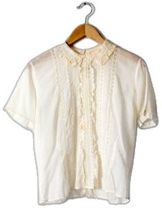 White Retro Top With Ruffled Collar, Vintage Lace Collar Button-up Top, Retro White Top With Ruffled Collar, Vintage White Top With Lace Collar For Daywear, Retro White Tops With Lace Trim, Classic Tops With Lace Trim And Peter Pan Collar, Classic Cotton Lace Top Blouse, Retro Short Sleeve Blouse With Lace Trim, Retro White Tops With Lace Collar