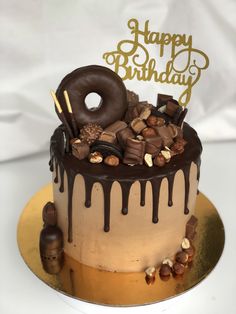 a birthday cake with chocolate and nuts on top