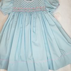 Gorgeous Must Have Party Dress Is Brand New With Tags And Beautiful The Color Is Gorgeous In Person Light Blue Dress With Pink& White Pearls In The Smocking. Classy And Stylish So Cute I Have 24 Months 2t Or 3t Available Cute Short Sleeve Dress With Smocked Cuffs, Fitted Blue Smocked Dress For Playtime, Light Blue Short Sleeve Dress With Smocked Bodice, Light Blue Fitted Smocked Cotton Dress, Fitted Light Blue Smocked Cotton Dress, Light Blue Fitted Cotton Smocked Dress, Casual Smocked Dress For Playtime, Short Sleeve Dresses With Smocked Back For Playtime, Casual Fitted Smocked Dress For Playtime