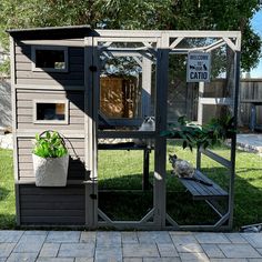 a chicken coop with two chickens in it