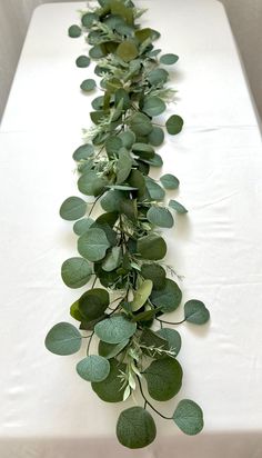 a long table with green leaves on it