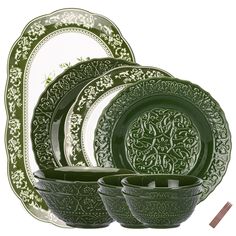 green dinnerware set with ornate design on the front and side dishes in the back