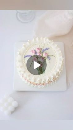 a white plate topped with a cake covered in frosting