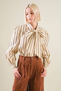 A striped woven top with high neckline with tie, long sleeve and button down Details: Self : 100% Cotton Size & Fit - Model is 5`8" And Wearing Size Small- Measurements Taken From Size Small- Approx. Length: 24" Chic Pinstripe Blouse With Striped Collar, Fall Long Sleeve Blouse With Striped Collar, Striped Blouse For Workwear In Fall, Fall Striped Blouse For Work, Chic Long Sleeve Blouse With Vertical Stripes, Fall Workwear Striped Blouse, Classic Striped Collar Blouse For Fall, Classic Blouse With Striped Collar For Fall, Classic Fall Blouse With Striped Collar