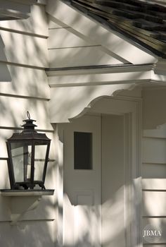 an old fashioned lantern on the side of a house