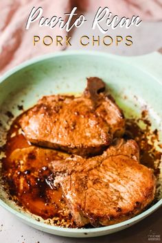 pork chops in a skillet with sauce and seasoning on the side, ready to be eaten