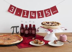 a table topped with pies and bottles of soda