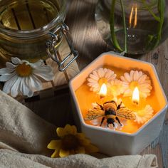 a bee sitting on top of a table next to flowers