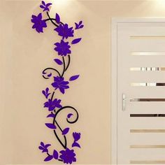 purple flowers on the side of a white door