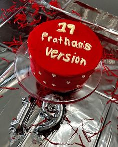 a red cake sitting on top of a glass plate