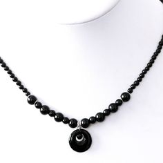 This delicate, lightweight black onyx necklace is 17" long with a 3.25" sterling silver extender.  Suitable for casual wear, business or formal occasions.  Handmade using the following high-quality materials: Black onyx round beads Black onyx donut pendant (approx 0.6" diameter) Sterling silver wire, spacers, bead caps, chain, findings, and hook and eye clasp -- The necklace will come in a brown kraft gift box with ribbon and will be packaged in a protective mailer and sent via U.S.P.S. first class mail. Please refer to my shop "Policies" for more information on shipping and insurance. -- Companion pieces (bracelet and/or earrings) may be available in the relevant shop sections of Red Yucca Designs. Please be sure to browse the rest of my shop if you would like to create a coordinated set. Adjustable Onyx Beaded Necklaces With Polished Beads, Adjustable Onyx Bead Necklaces, Adjustable Onyx Round Bead Necklaces, Adjustable Round Onyx Necklaces, Adjustable Minimalist Onyx Necklace, Adjustable Onyx Necklaces, Minimalist Adjustable Onyx Necklace, Onyx Necklace With 8mm Round Beads, Luxury Adjustable Onyx Beaded Necklaces