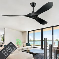 a living room with a ceiling fan and remote control