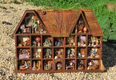 a doll house made out of wood with many items in it's display case