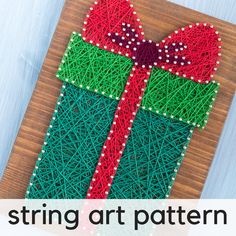 string art present box with red and green ribbon